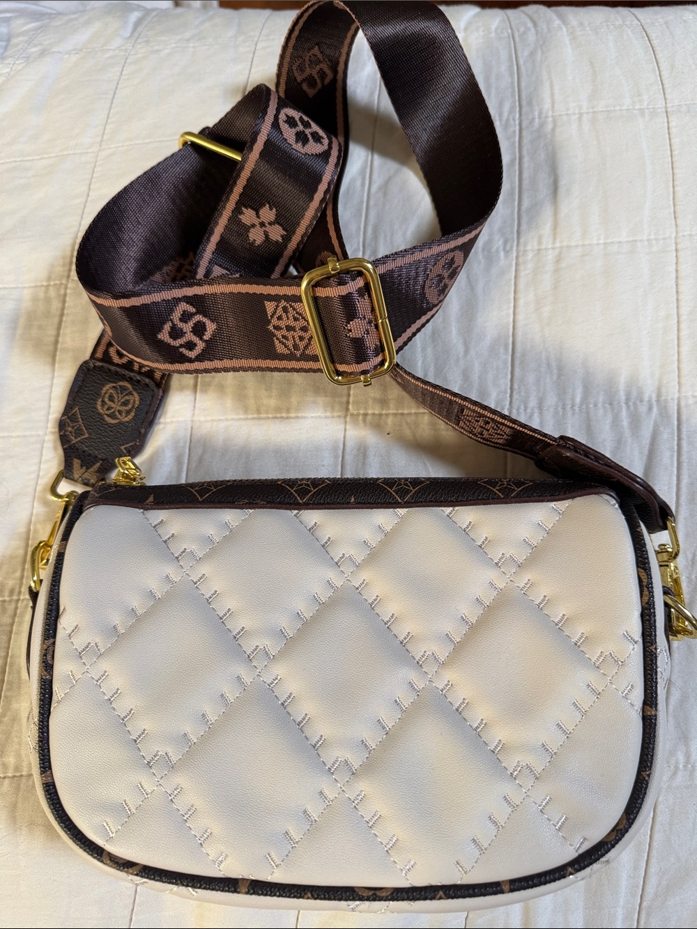 Cream Quilted Crossbody Bag with Brown Monogram Strap. 9”x6”. Adjustable strap.